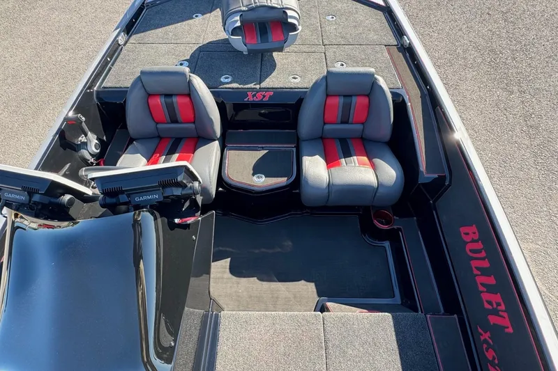 Slide: The Image of 2026 Bullet 21XST boat interior with red and gray seating, Garmin displays, and sleek design. - 4
