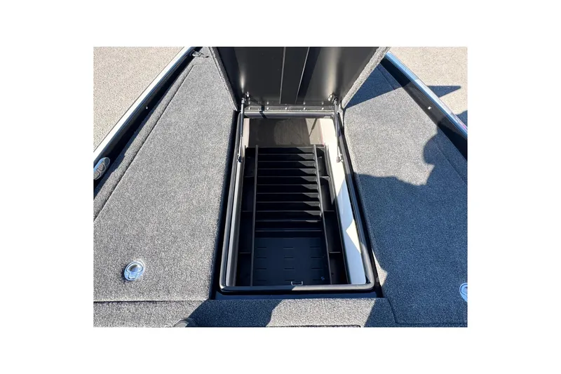 Slide: The Image of Open storage compartment on 2026 Bullet 21XST boat deck, featuring carpeted surfaces. - 6