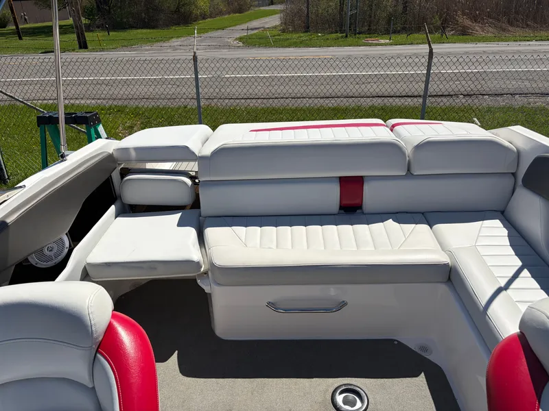Slide: The Image of Interior of a 2008 Regal 2200 Bowrider boat with white seating. - 12