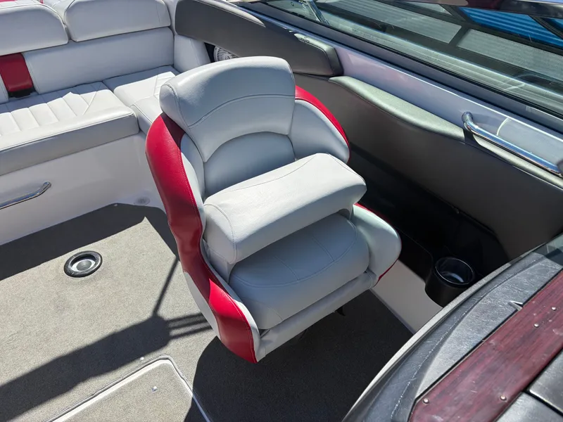 Slide: The Image of Interior of a 2008 Regal 2200 Bowrider with gray and red seating. - 16