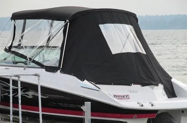 Slide: The Image of 2008 Regal 2200 Bowrider with black canopy on lake. - 22