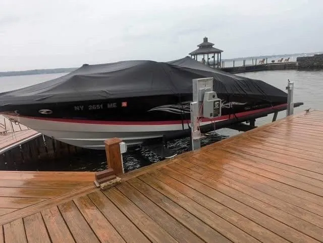 Slide: The Image of 2008 Regal 2200 Bowrider boat on a dock with cover. - 23