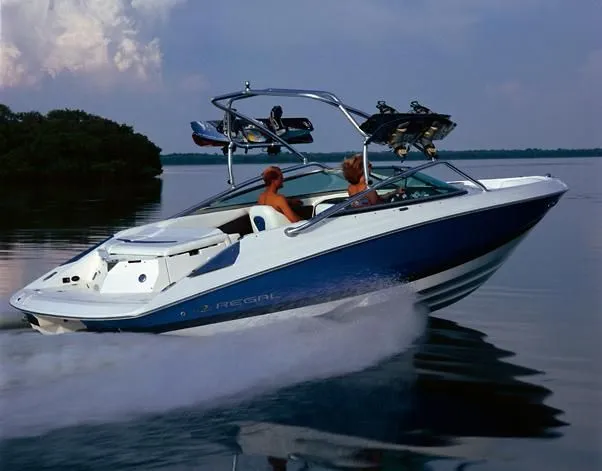 Slide: The Image of 2008 Regal 2200 Bowrider on calm water, two people onboard. - 24