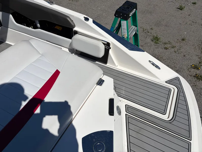 Slide: The Image of 2008 Regal 2200 Bowrider boat with gray deck and white seating. - 7