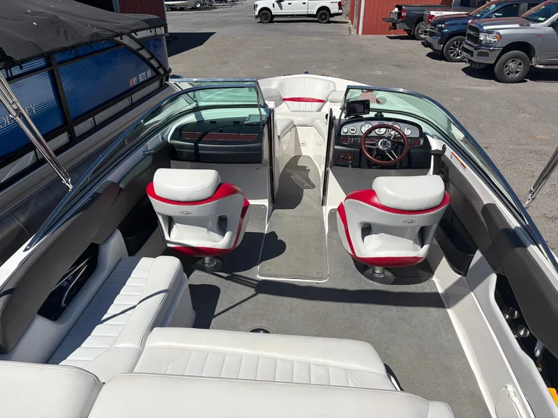 Slide: The Image of Interior of a 2008 Regal 2200 Bowrider boat with red and white seats. - 9