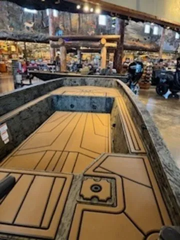 Slide: The Image of Grizzly G1650T DB 2026 boat in showroom with wood paneling. - 16