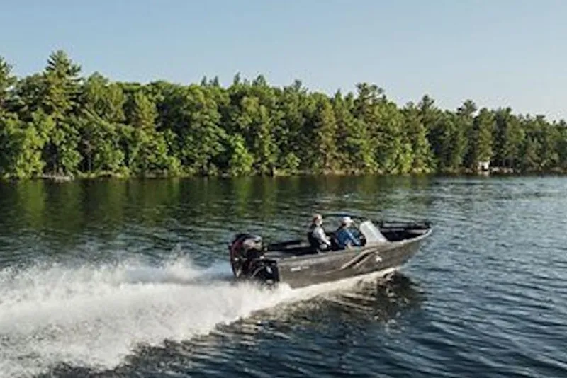 Slide: The Image of 2026 Crestliner 1750 Hawk WT boat cruising on a scenic lake. - 4