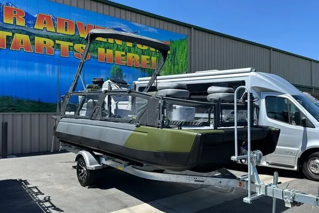 Slide: The Image of 2026 Sea-Doo PB SWT FISH boat on trailer outside warehouse. - 25