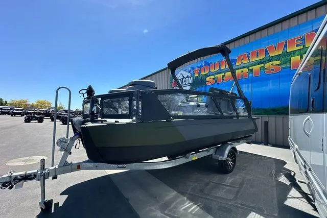 Slide: The Image of 2026 Sea-Doo PB SWT FISH boat on trailer outside warehouse. - 29