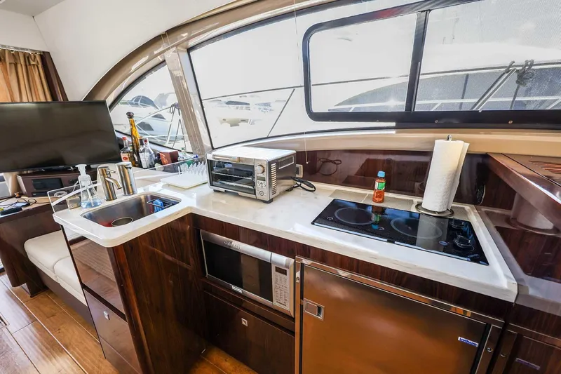 Slide: The Image of Luxurious 2017 Sea Ray Sundancer 400 yacht kitchen with modern appliances and sleek design. - 12