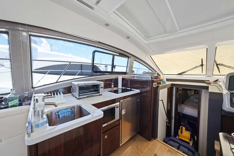 Slide: The Image of Interior of 2017 Sea Ray Sundancer 400 yacht featuring modern kitchen amenities. - 15