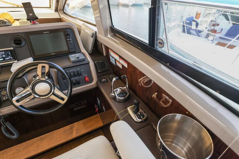 Slide: The Image of Interior helm of 2017 Sea Ray Sundancer 400 yacht with modern controls and steering wheel. - 17