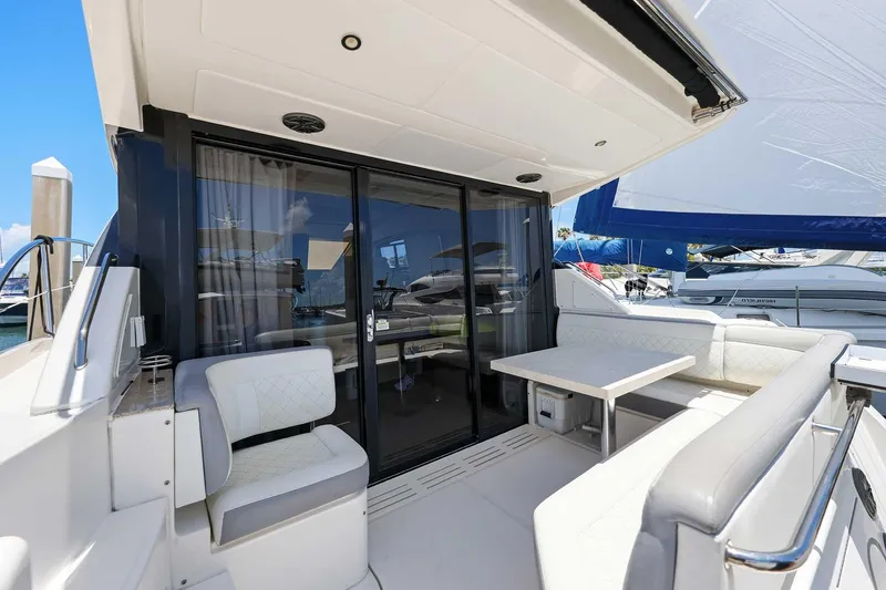 Slide: The Image of 2017 Sea Ray Sundancer 400 yacht with elegant seating and table on deck. - 2