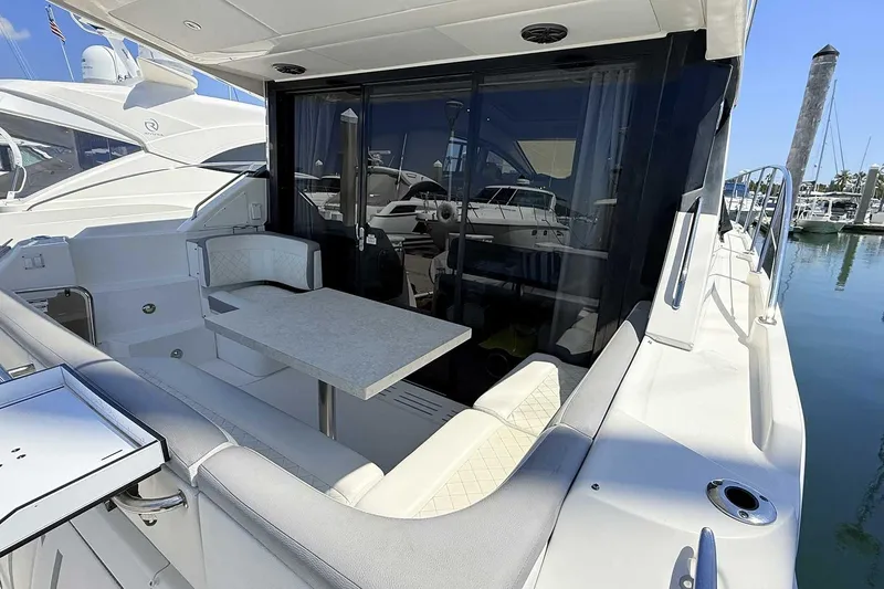 Slide: The Image of 2017 Sea Ray Sundancer 400 yacht with outdoor seating and table at marina. - 3