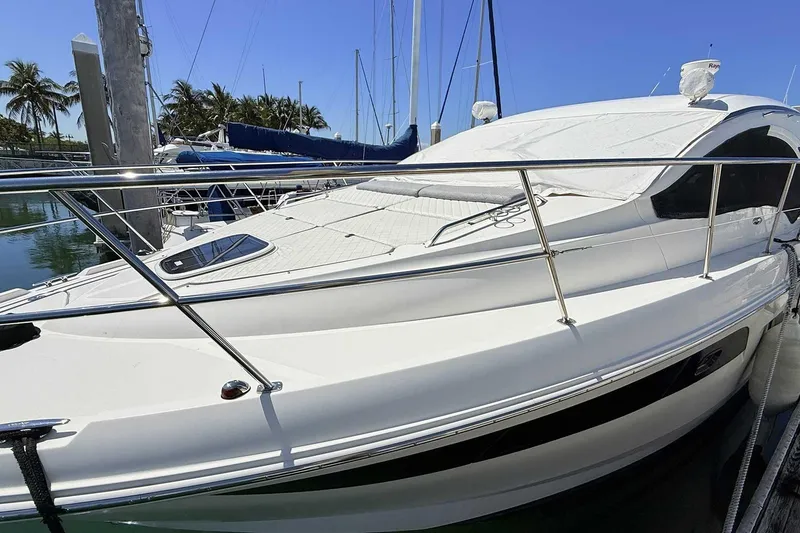 Slide: The Image of 2017 Sea Ray Sundancer 400 yacht docked, featuring sleek design and sun cover. - 30