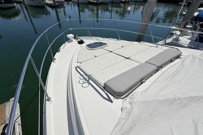 Slide: The Image of 2017 Sea Ray Sundancer 400 yacht with cushioned deck, docked in marina. - 32