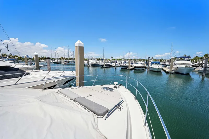 Slide: The Image of 2017 Sea Ray Sundancer 400 docked in a sunny marina with clear blue skies. - 33