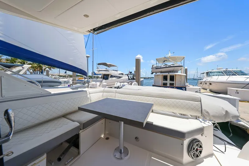 Slide: The Image of 2017 Sea Ray Sundancer 400 yacht interior with seating and table at marina. - 4