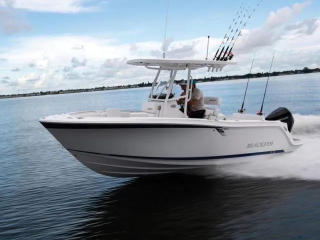 The Image of 2023 Blackfin 222 CC boat cruising on calm water. - 1