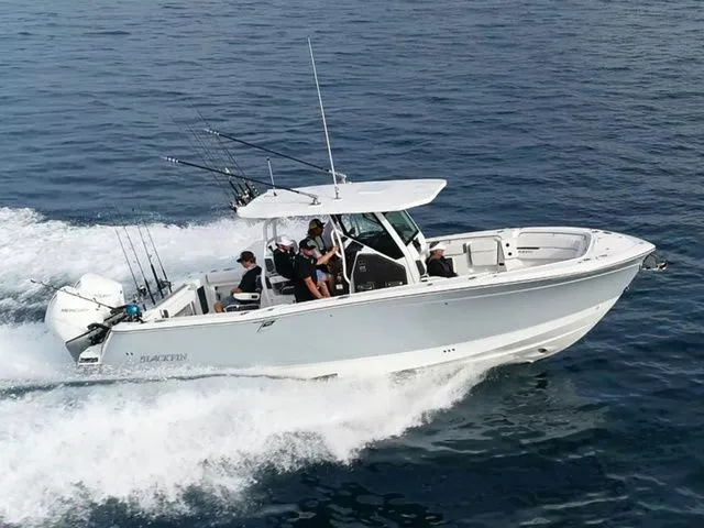 The Image of 2022 Blackfin 302 CC boat cruising on the ocean. - 1