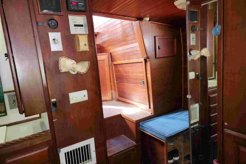 Slide: The Image of Interior of a 2000 Bruce Roberts custom boat with wooden paneling and blue seating. - 10