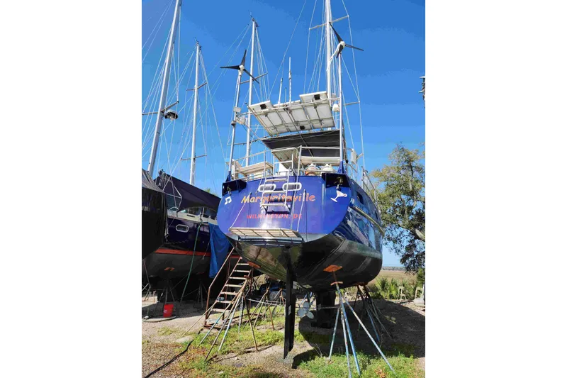 Slide: The Image of Sailboat "Margaritaville" on land, Custom Bruce Roberts 2000 model, under clear blue sky. - 15