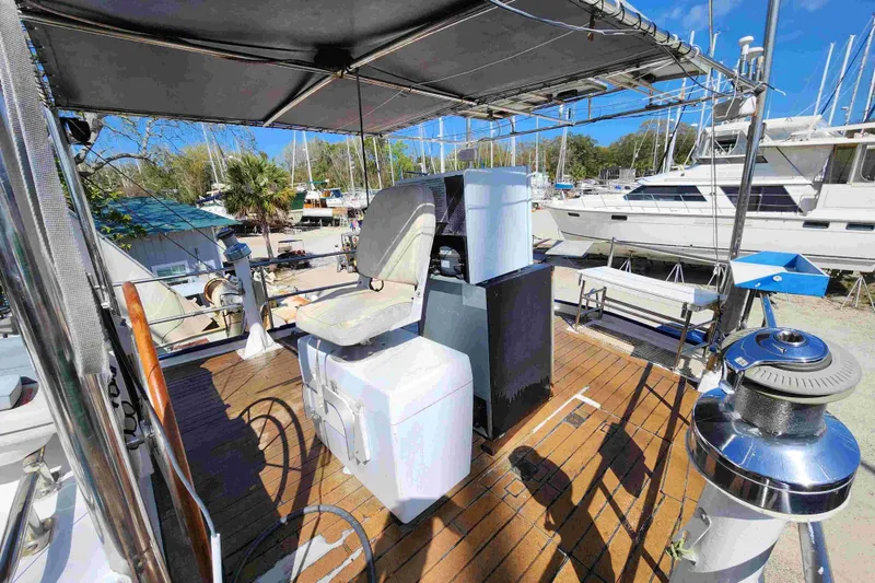 Slide: The Image of Deck of 2000 Custom Bruce Roberts boat with seating and equipment, docked at marina. - 19