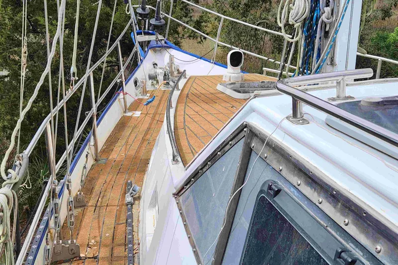 Slide: The Image of Deck of 2000 Custom Bruce Roberts sailboat with wooden flooring and rigging. - 21