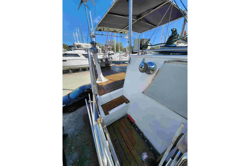 Slide: The Image of Custom Bruce Roberts 2000 boat deck with wooden flooring and metal railings. - 22
