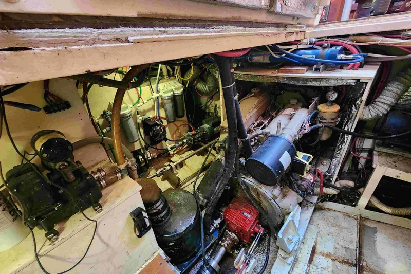 Slide: The Image of Engine room of a 2000 Custom Bruce Roberts boat, showcasing mechanical components and wiring. - 25