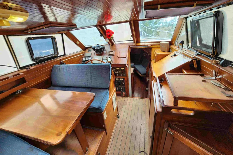 Slide: The Image of Interior of 2000 Custom Bruce Roberts boat with wooden furnishings and navigation area. - 4