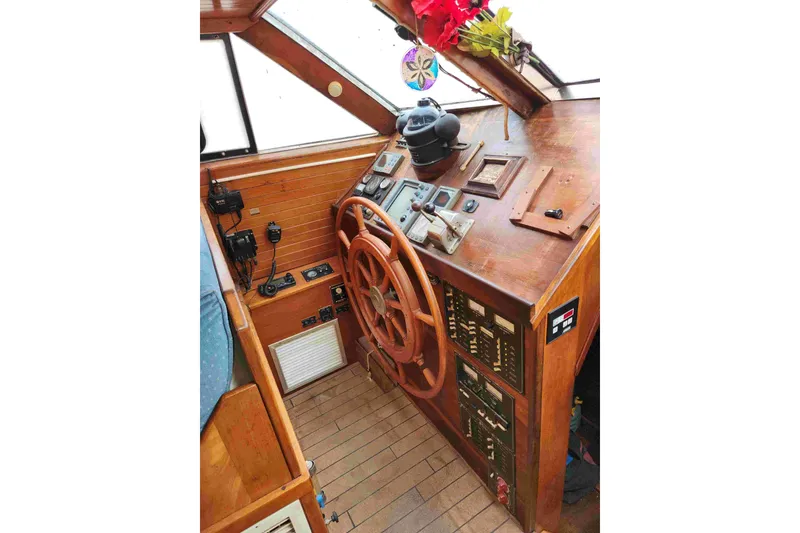Slide: The Image of Wooden helm station of a 2000 Custom Bruce Roberts boat, featuring navigation instruments. - 5