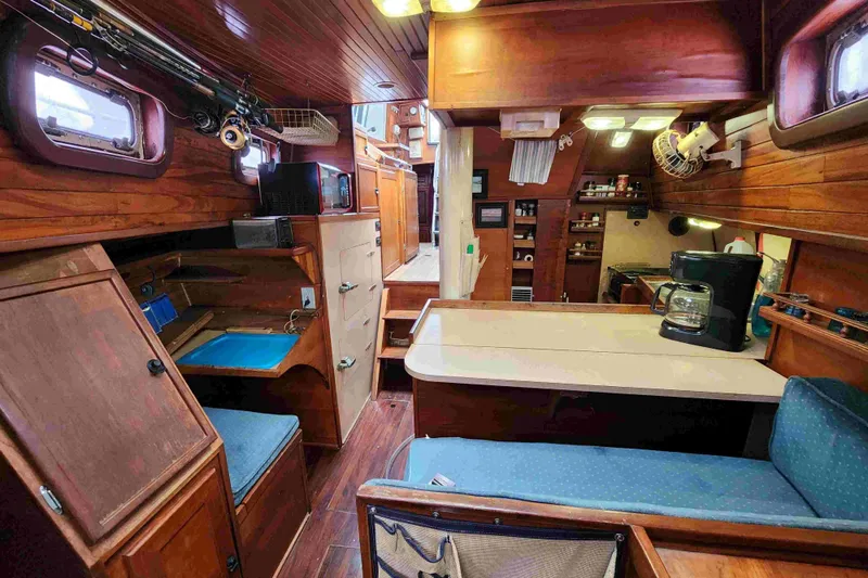 Slide: The Image of Interior of a 2000 Custom Bruce Roberts boat with wooden furnishings and kitchen area. - 6