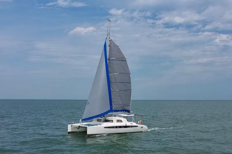 The Image of Sailing catamaran Dolphin 460, 2007 model, cruising on open sea under clear skies. - 0