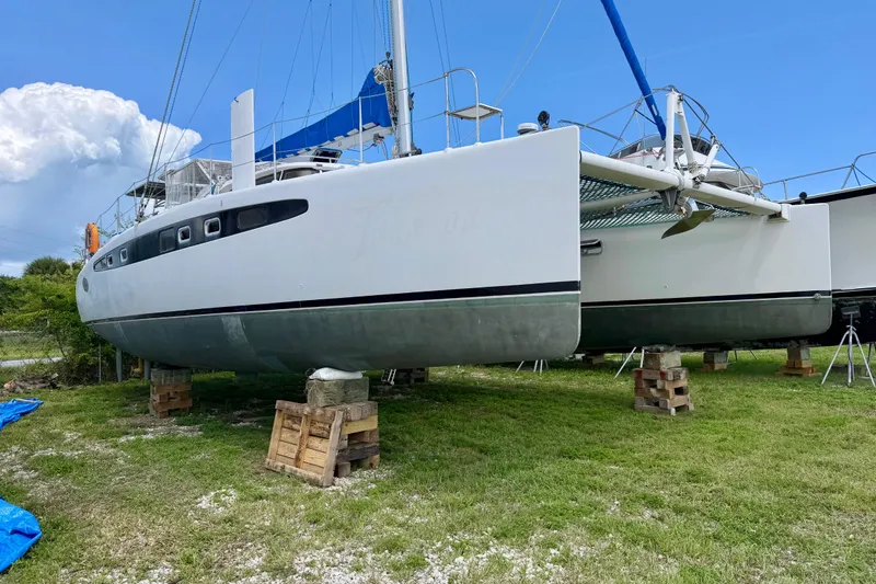 Slide: The Image of Catamaran Dolphin 460, 2007 model, on land with blue sky background. - 119