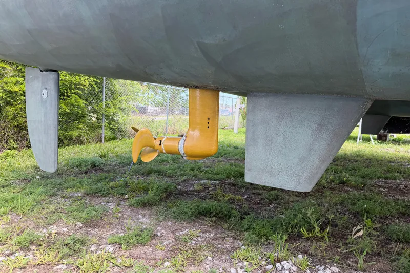 Slide: The Image of Underwater view of a 2007 Dolphin 460 sailboat's rudder and propeller on grass. - 120