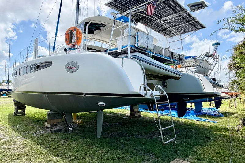 Slide: The Image of Catamaran Dolphin 460, 2007 model, on land with solar panels and ladder access. - 122