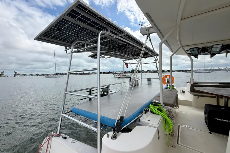 Slide: The Image of Catamaran with solar panels on deck, Dolphin 460 model, 2007, docked near a bridge. - 15