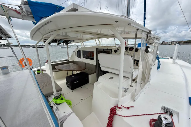 Slide: The Image of Spacious deck of 2007 Dolphin 460 catamaran with seating and navigation area. - 16
