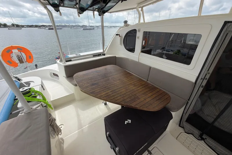 Slide: The Image of Outdoor seating area on a 2007 Dolphin 460 yacht with wooden table and ocean view. - 17
