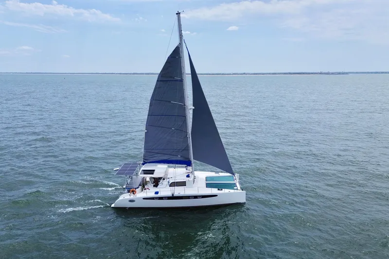 Slide: The Image of Sailing catamaran Dolphin 460, 2007 model, cruising on open sea under clear skies. - 2
