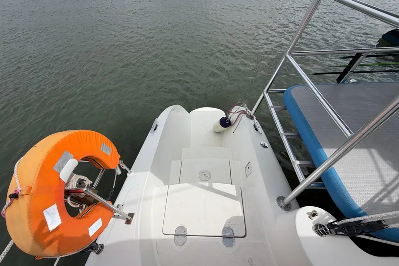 Slide: The Image of Rear deck of a 2007 Dolphin 460 boat with life preserver and railing. - 24