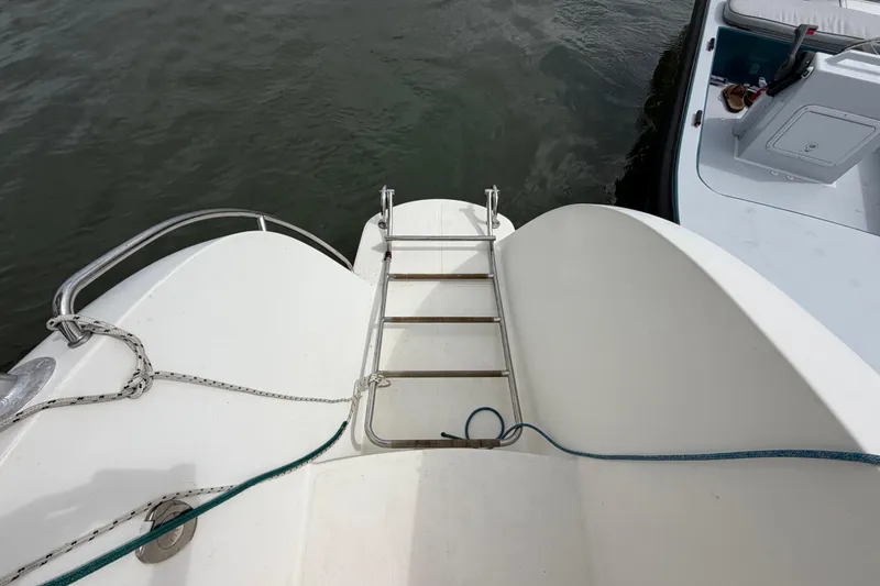 Slide: The Image of Boat deck with ladder and ropes, Dolphin 460 model, 2007, near water. - 25