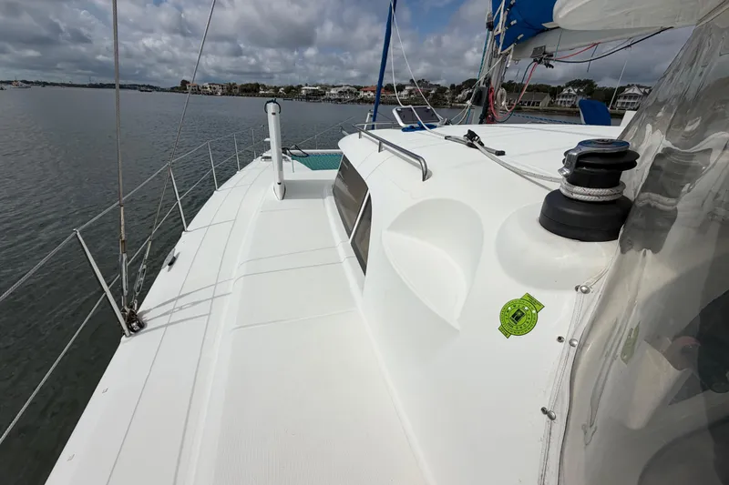 Slide: The Image of Sailing catamaran Dolphin 460, 2007 model, on calm waters under cloudy skies. - 29