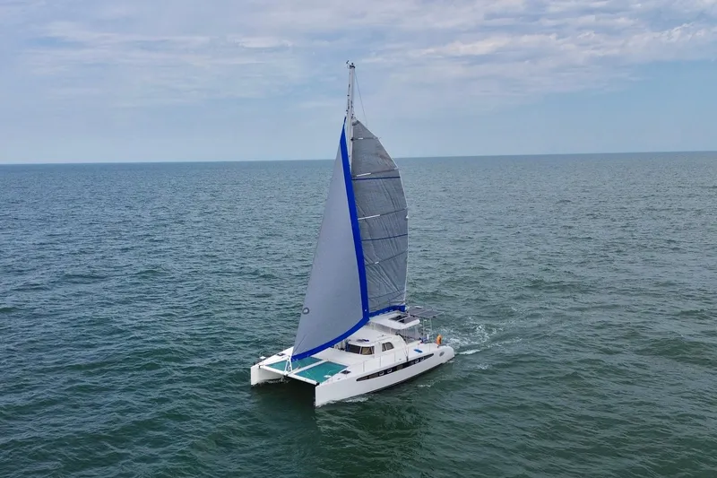 Slide: The Image of Sailing catamaran Dolphin 460, 2007 model, cruising on open sea under clear skies. - 3