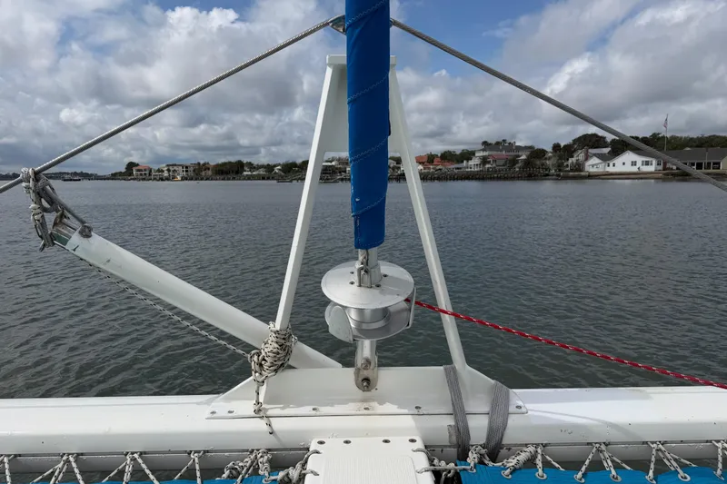Slide: The Image of Bow view of 2007 Dolphin 460 sailboat with rigging and coastal background. - 35