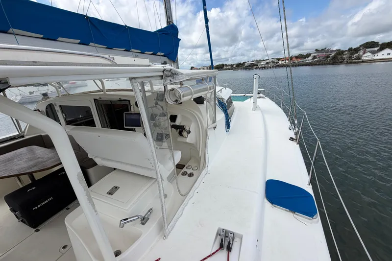 Slide: The Image of Sailboat Dolphin 460, 2007 model, docked with blue sail cover and spacious deck. - 36