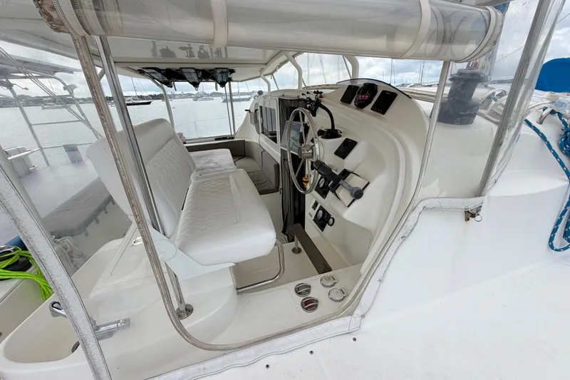 Slide: The Image of Interior view of a 2007 Dolphin 460 yacht cockpit with steering wheel and seating. - 37