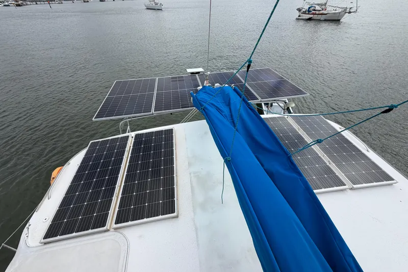 Slide: The Image of Solar panels on a 2007 Dolphin 460 boat, anchored on a calm waterway. - 38