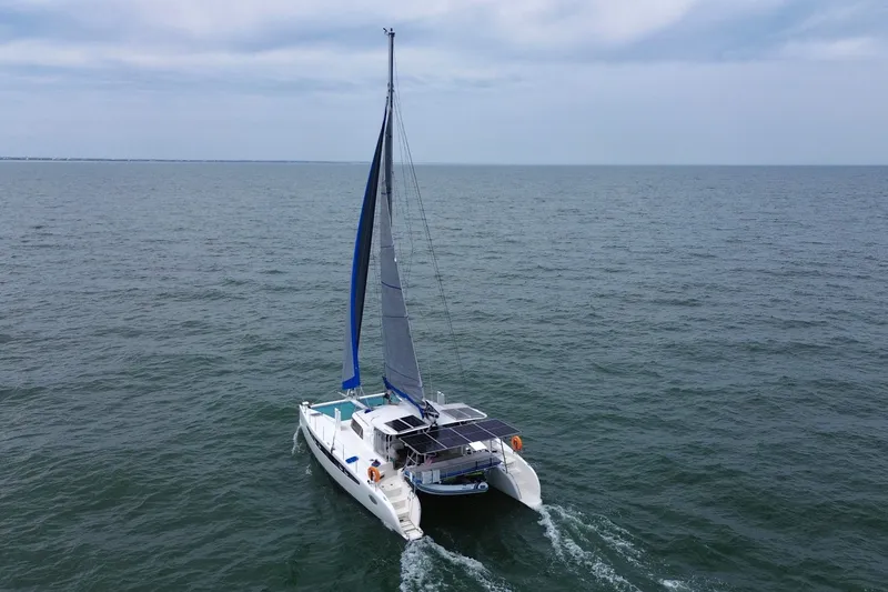 Slide: The Image of Sailing catamaran Dolphin 460, 2007 model, cruising on open sea under cloudy skies. - 4